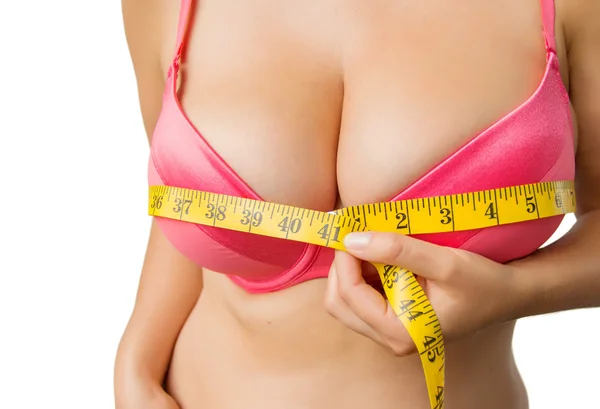 Woman with big boobs measuring her bust — Stock Photo, Image